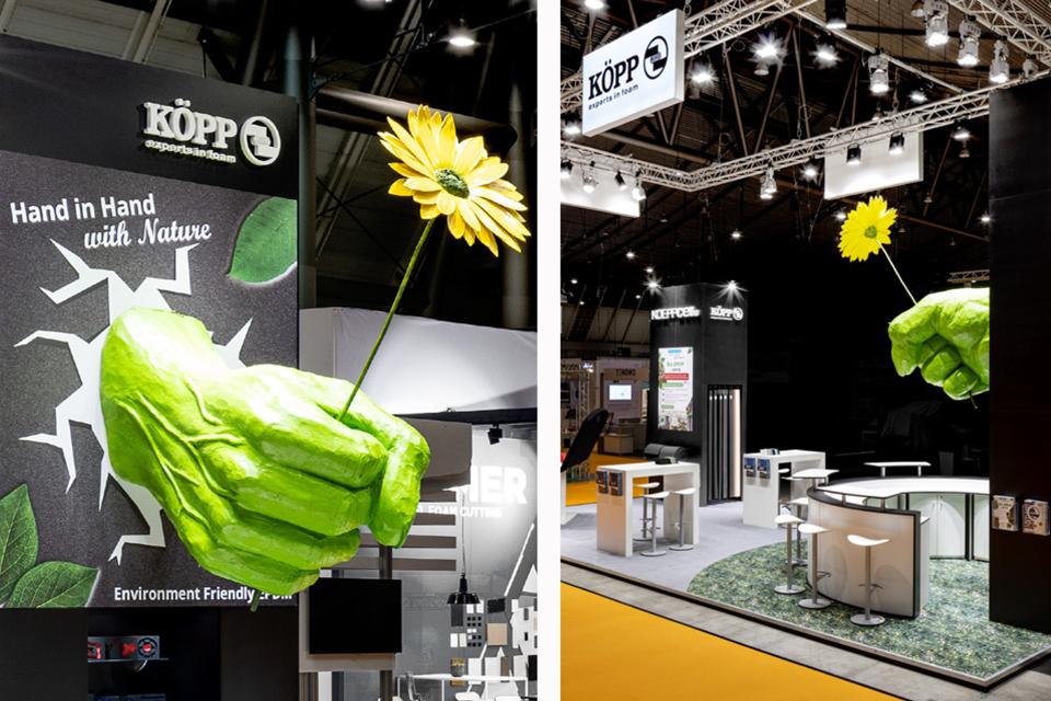 Exhibition stand Köpp Foam Expo 2021 the giant green fist holding a flower
